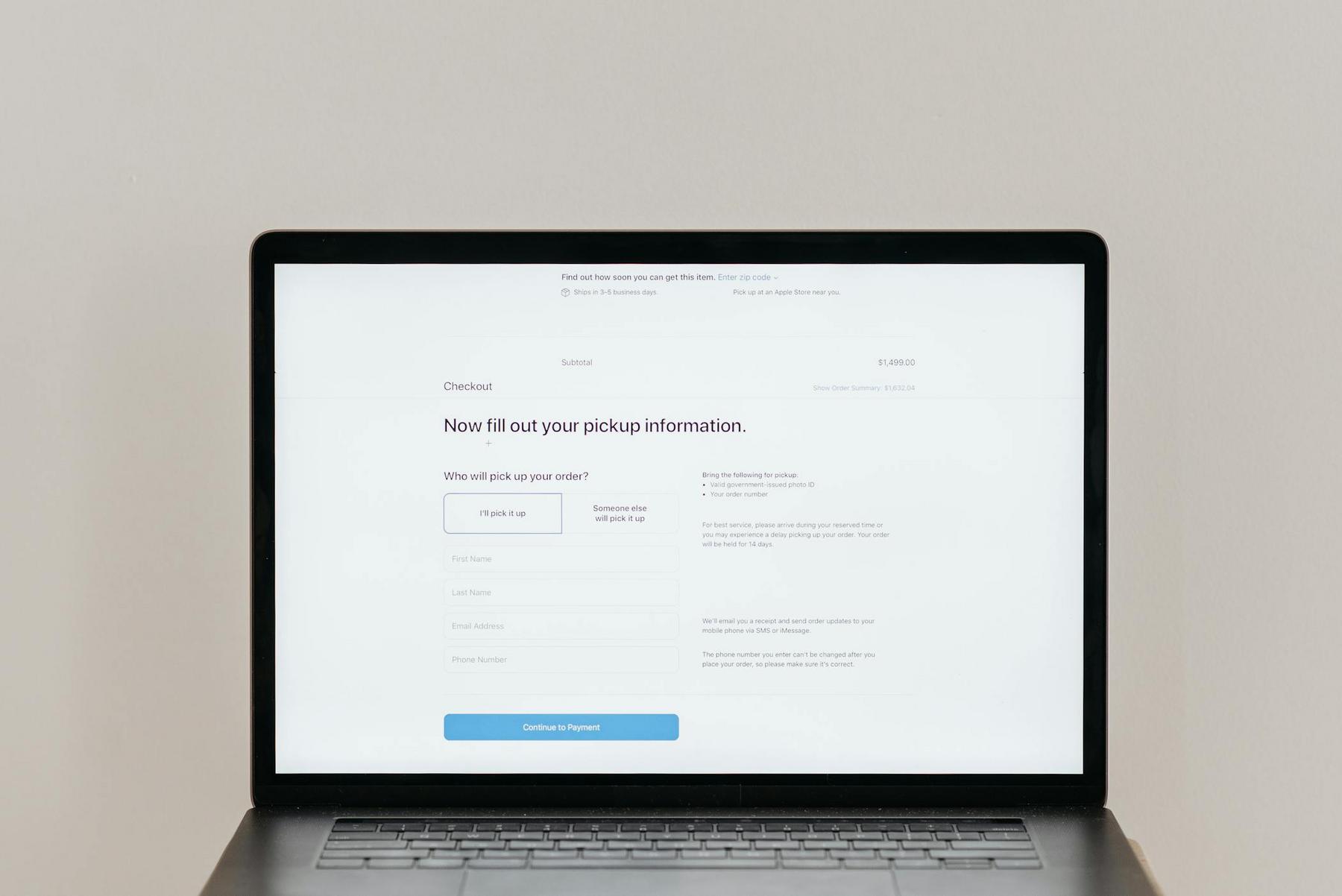A laptop screen displaying an online checkout page prompting the user to fill out pickup information, including fields for name and contact details.