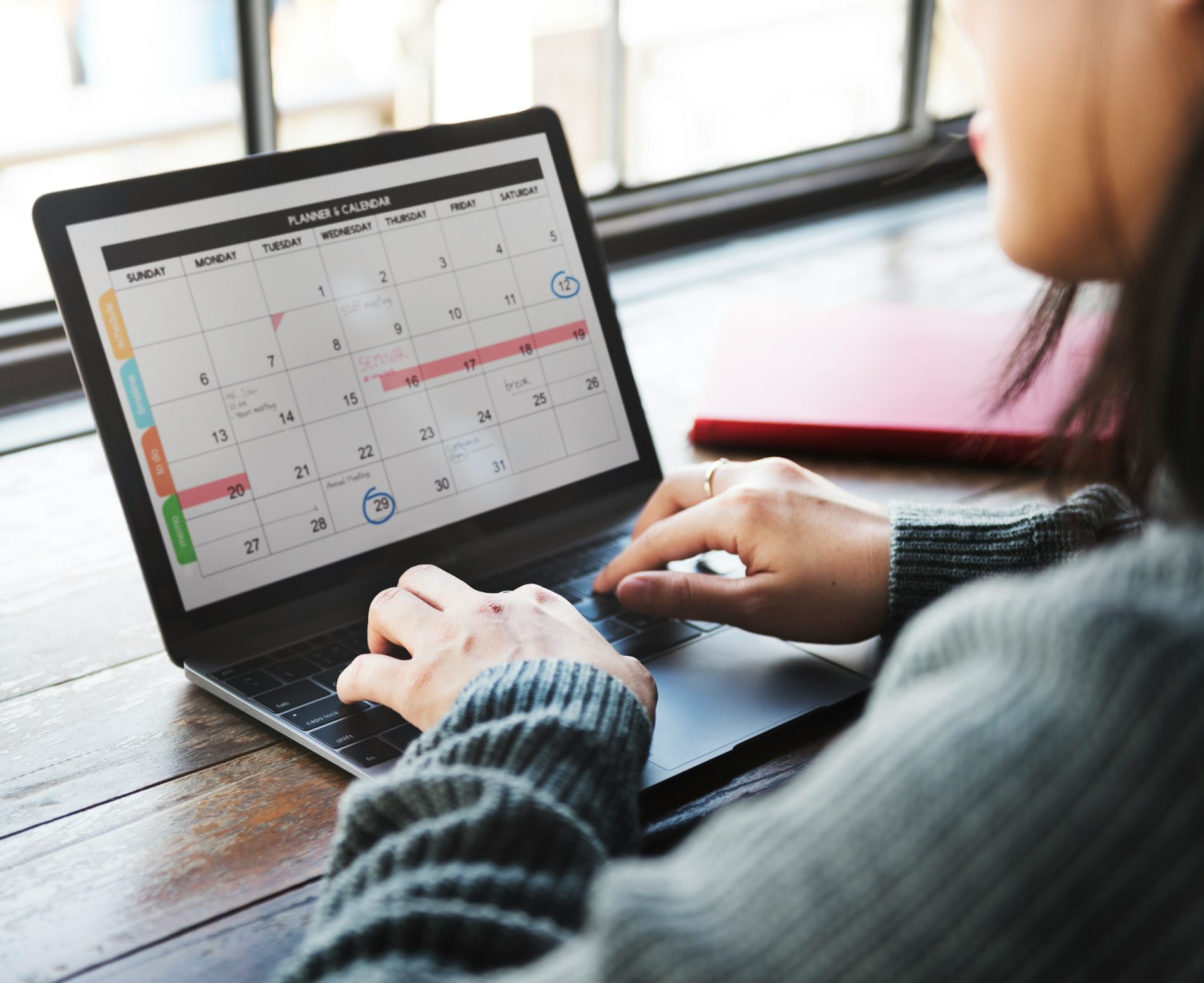 A person sits focused, his laptop glowing with a digital calendar, subtly marked with reminders on important dates, like "When Are Taxes Due," ensuring no crucial deadlines slip by unnoticed.